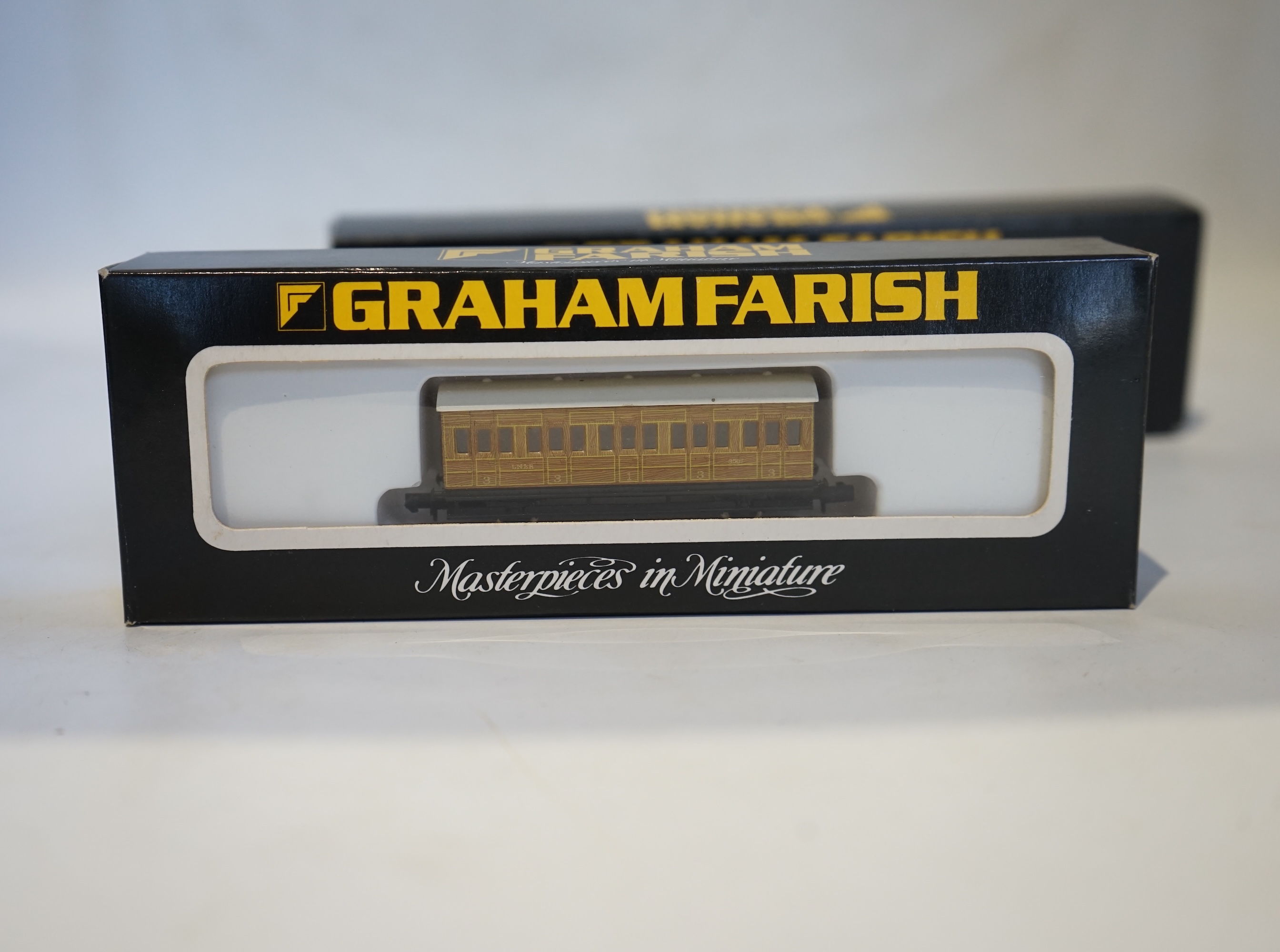 Twenty boxed Graham Farish N gauge railway; an LNER Class V2 2-6-2 tender locomotive, Coldstreamer, (372-602), together with nineteen LNER teak 4-wheel coaches. Condition - good.